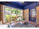 Relaxing sunroom with bench seating, brick walls, and large windows with neighborhood views at 1900 Ridgewood Ne Dr, Atlanta, GA 30307