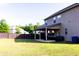 Spacious backyard with a covered patio, dark wooden fence, and ample green space at 375 Madison Grace Ave, Mcdonough, GA 30252