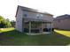 Backyard features a covered patio with furniture, offering an ideal outdoor living space at 375 Madison Grace Ave, Mcdonough, GA 30252