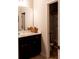 Bathroom with a dark wood vanity, mirror, and toilet with a butterfly-patterned shower curtain in view at 375 Madison Grace Ave, Mcdonough, GA 30252