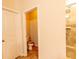 View of the bathroom with brown tiling and a toilet in a separate room at 375 Madison Grace Ave, Mcdonough, GA 30252