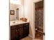Bathroom with a dark wood vanity, mirror, and toilet with a butterfly-patterned shower curtain in view at 375 Madison Grace Ave, Mcdonough, GA 30252