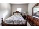 Bedroom features a full-size bed with wood frame, dresser with mirror and natural light from the window at 375 Madison Grace Ave, Mcdonough, GA 30252