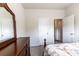 Bedroom boasts a dark wood dresser, adjacent doors and neutral walls, offering a serene atmosphere at 375 Madison Grace Ave, Mcdonough, GA 30252
