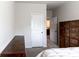 Bedroom features a queen bed, dark wood dressers, and access to bathroom and closet doors at 375 Madison Grace Ave, Mcdonough, GA 30252