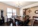 Dining room features a table with seating, a chandelier, and a view of the front entrance at 375 Madison Grace Ave, Mcdonough, GA 30252