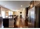 Open concept kitchen with stainless steel appliances and a granite countertop island with barstool seating at 375 Madison Grace Ave, Mcdonough, GA 30252