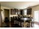 Stylish kitchen island with seating, stainless steel appliances, and dark cabinets for modern living at 375 Madison Grace Ave, Mcdonough, GA 30252
