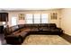 Spacious living room with plush, oversized sectional sofa and neutral-toned rug at 375 Madison Grace Ave, Mcdonough, GA 30252