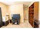 This living room provides ample room with a bookshelf, television, and a view to the hall at 375 Madison Grace Ave, Mcdonough, GA 30252