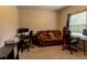 This cozy living room features comfortable seating and a work area with monitors at 375 Madison Grace Ave, Mcdonough, GA 30252