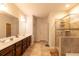 Main bathroom featuring a tiled shower, double vanity, tile floors, and a large mirror at 375 Madison Grace Ave, Mcdonough, GA 30252