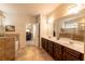 Main bathroom featuring a soaking tub, double vanity, and a view into the main bedroom at 375 Madison Grace Ave, Mcdonough, GA 30252