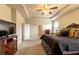Large main bedroom featuring a tray ceiling, ceiling fan, carpeted floor, and traditional-style furniture at 375 Madison Grace Ave, Mcdonough, GA 30252