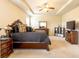 Spacious main bedroom featuring a tray ceiling, ceiling fan, carpeted floor, and traditional-style furniture at 375 Madison Grace Ave, Mcdonough, GA 30252