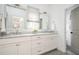 Elegant bathroom with double vanity sinks, marble countertop, and stylish mirrors, offering a luxurious feel at 588 Bismark Ne Rd, Atlanta, GA 30324
