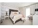 Serene bedroom with cloud wallpaper, a tufted headboard, and cozy seating area at 588 Bismark Ne Rd, Atlanta, GA 30324