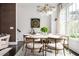 Dining room boasts an elegant chandelier, seating for six, and views of backyard at 588 Bismark Ne Rd, Atlanta, GA 30324