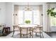 Dining room features a modern chandelier, large windows, and seating for six at 588 Bismark Ne Rd, Atlanta, GA 30324