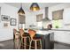 Elegant kitchen island with modern pendant lights, seating, and sleek white countertops at 588 Bismark Ne Rd, Atlanta, GA 30324