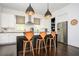 Bright eat-in kitchen offers stainless appliances, island seating, and stylish pendant lighting at 588 Bismark Ne Rd, Atlanta, GA 30324
