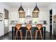 Modern kitchen featuring a center island with seating, stylish pendant lights, and white cabinetry at 588 Bismark Ne Rd, Atlanta, GA 30324
