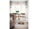 Cozy living room featuring a neutral-toned sofa, modern chandelier and a cuddly dog at 588 Bismark Ne Rd, Atlanta, GA 30324