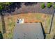 Overhead shot of the house, highlighting the backyard with a patio, fire pit, and manicured lawn at 6550 Lantana Village Way, Cumming, GA 30028