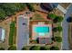 Aerial view of the community pool, parking area, and surrounding green space, perfect for recreation at 6550 Lantana Village Way, Cumming, GA 30028