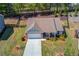 An aerial view of a single-story home showcasing its neat landscaping, fenced backyard, and inviting front porch at 6550 Lantana Village Way, Cumming, GA 30028