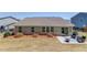 Well-kept backyard with patio, seating area, fire pit, and a backdrop of colorful flowers at 6550 Lantana Village Way, Cumming, GA 30028