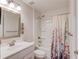 Bathroom featuring a bathtub with shower and floral curtain at 6550 Lantana Village Way, Cumming, GA 30028