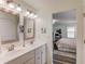 Bright bathroom vanity with double sinks and mirrors open to bedroom at 6550 Lantana Village Way, Cumming, GA 30028