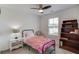 Cozy bedroom with ceiling fan, window, and bookshelves at 6550 Lantana Village Way, Cumming, GA 30028