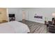 Spacious bedroom with a fireplace, television, and comfortable seating at 6550 Lantana Village Way, Cumming, GA 30028