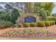 Stone entrance sign for Crescent Landing, surrounded by colorful flower beds and manicured shrubs at 6550 Lantana Village Way, Cumming, GA 30028