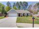Charming single-story home featuring a well-manicured lawn, brick facade, and a welcoming front porch with a bench at 6550 Lantana Village Way, Cumming, GA 30028