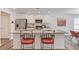 Bright kitchen with stainless steel appliances, granite countertops, and a breakfast bar with seating at 6550 Lantana Village Way, Cumming, GA 30028