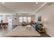 Bright, open-concept living room featuring hardwood floors, neutral colors, and plenty of natural light; adjacent to dining area at 6550 Lantana Village Way, Cumming, GA 30028