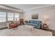 Cozy living room featuring a large window, tray ceiling, comfortable seating, and a stylish area rug at 6550 Lantana Village Way, Cumming, GA 30028