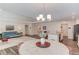 Open-concept living room with modern lighting, wood floors, and a comfortable blue couch at 6550 Lantana Village Way, Cumming, GA 30028