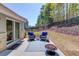 Rear patio with cozy seating area and backyard view at 6550 Lantana Village Way, Cumming, GA 30028