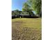 Large backyard with green grass and shade from trees at 6695 Cedar Hurst Trl, Atlanta, GA 30349