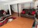 Finished basement with a comfortable seating arrangement, wood-look floors, and neutral walls at 6695 Cedar Hurst Trl, Atlanta, GA 30349