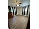 A bedroom features hardwood style floors and natural light from two windows at 6695 Cedar Hurst Trl, Atlanta, GA 30349