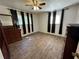 A bedroom featuring hardwood style floors and natural light from two windows at 6695 Cedar Hurst Trl, Atlanta, GA 30349