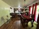Inviting dining area featuring wood floors, a stylish dining table, bar seating, and a view to the kitchen at 6695 Cedar Hurst Trl, Atlanta, GA 30349