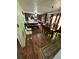 Inviting dining area featuring wood floors, a stylish dining table, and a view to the kitchen at 6695 Cedar Hurst Trl, Atlanta, GA 30349