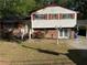 Charming two-story home featuring a combination of brick and siding with red shutters and a well-manicured lawn at 6695 Cedar Hurst Trl, Atlanta, GA 30349