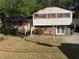 Charming home featuring a well-maintained lawn, brick accents, and a two-story design at 6695 Cedar Hurst Trl, Atlanta, GA 30349
